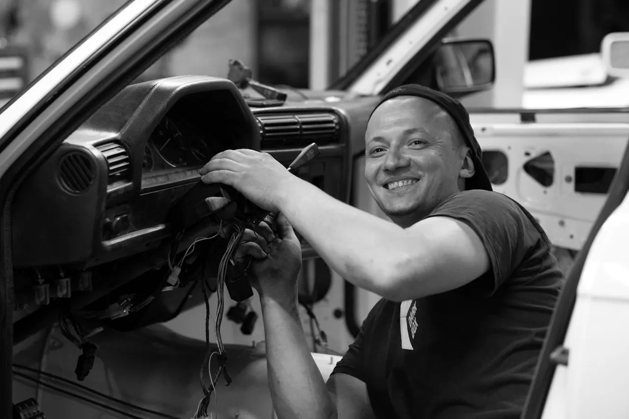 Smiling mechanic at work in his shop